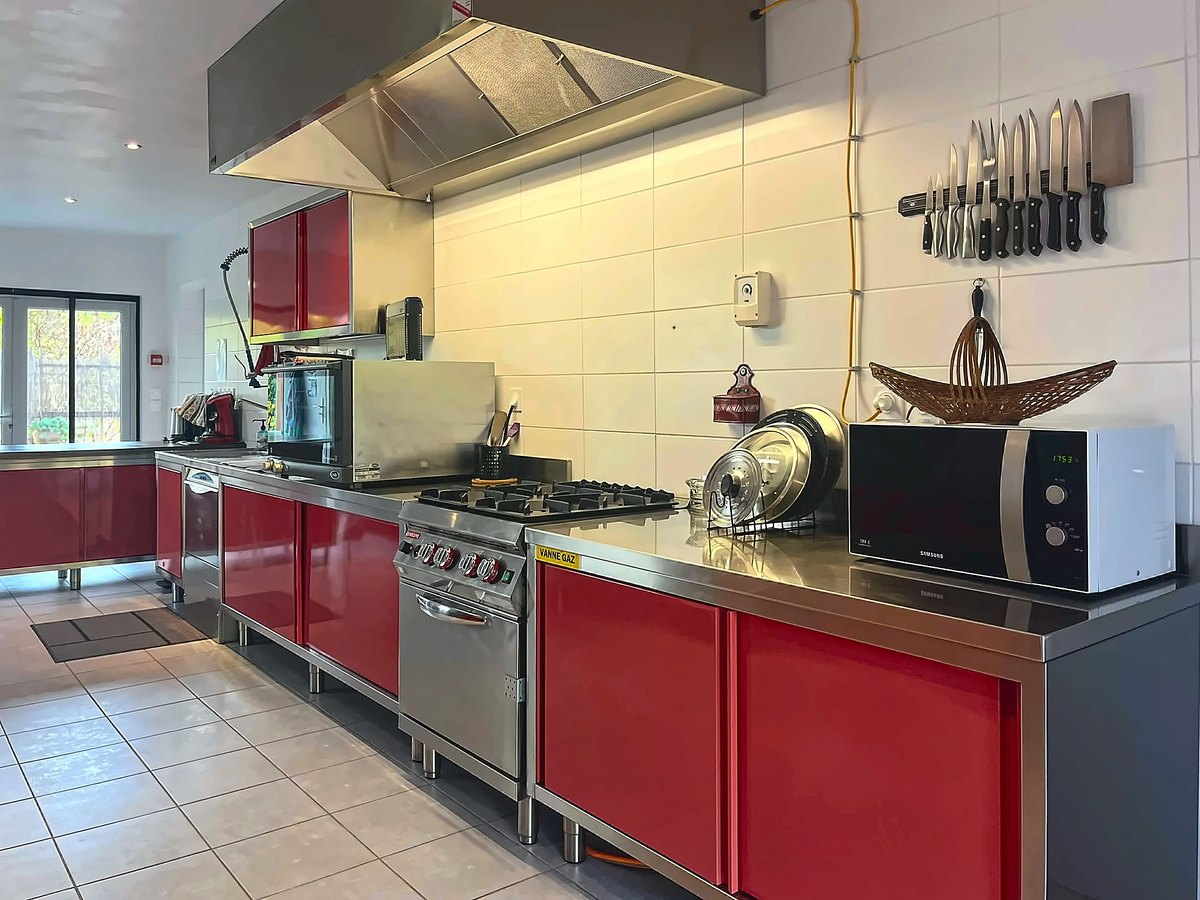 La cuisine professionnelle, son piano et ses façades rouges